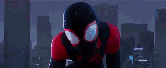 a close up of a person in a spiderman suit standing in front of a city .