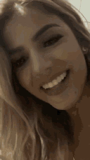 a close up of a woman 's face with a smile on her face