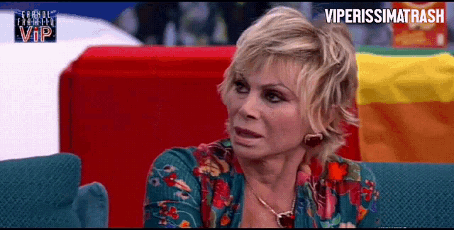 a woman sitting on a couch in front of a sign that says vip on it