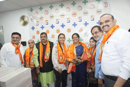 a group of people are posing for a picture in front of a wall that says ' 5 ' on it