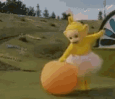 a teletubbies character is playing with an orange ball