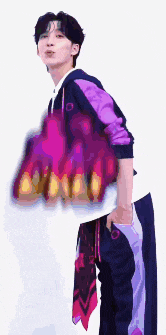 a man wearing a purple jacket and purple pants is holding a purple bag .