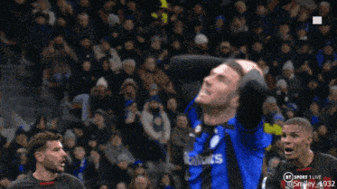 a soccer player wearing a blue jersey with the number 0 on the back