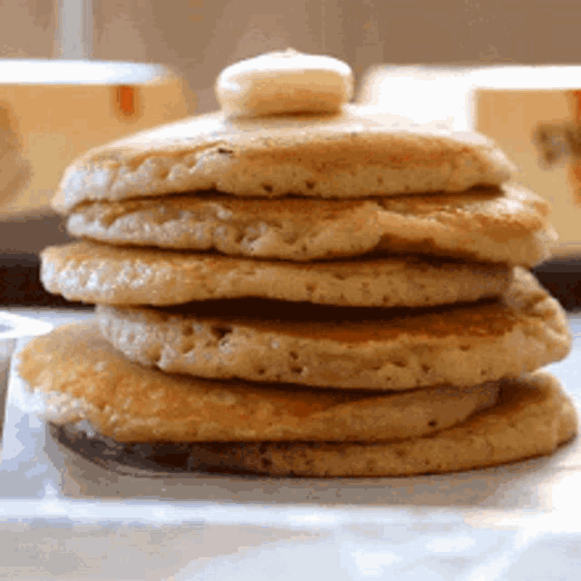 a stack of pancakes with syrup on top