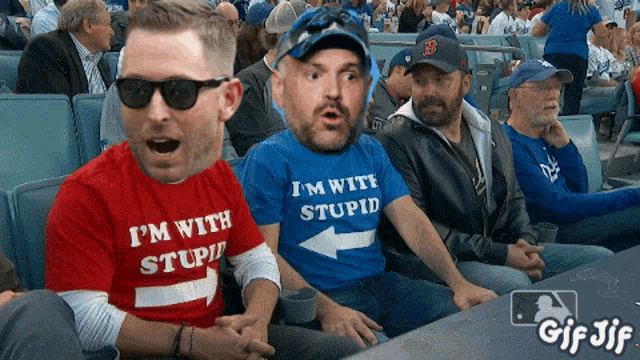 a man in a blue shirt that says i 'm with stupid
