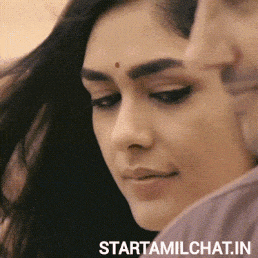 a close up of a woman 's face with the words starttamilchat.in written below it