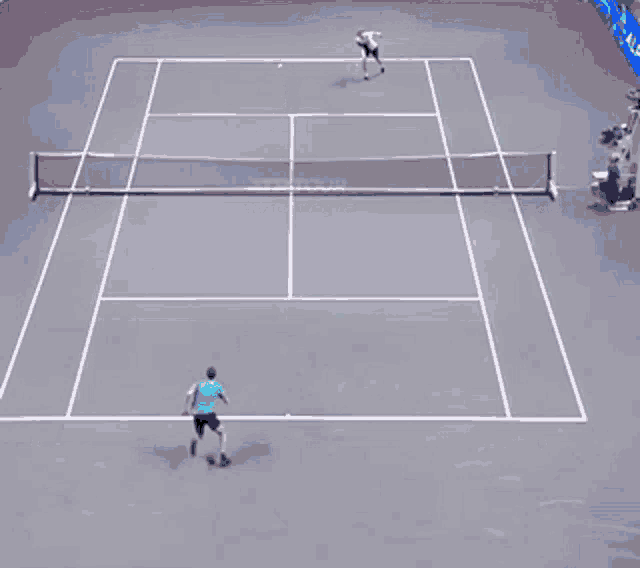 a man in a green shirt is doing a handstand on a tennis court in front of a sign that says " dumex "