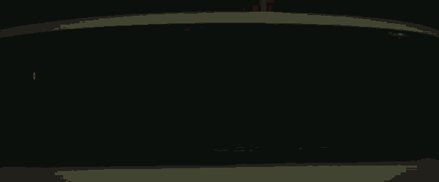 a man and a woman are kissing in a car behind a red curtain .