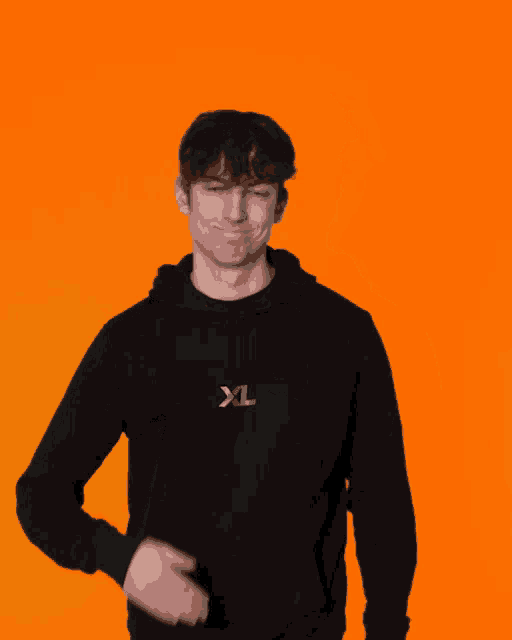 a man wearing a black hoodie with xl written on it