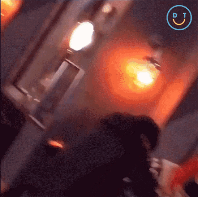 a blurred image of a person with a dt logo on the bottom