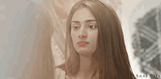 a woman is looking at herself in a mirror and the words soni gifs are on the bottom right