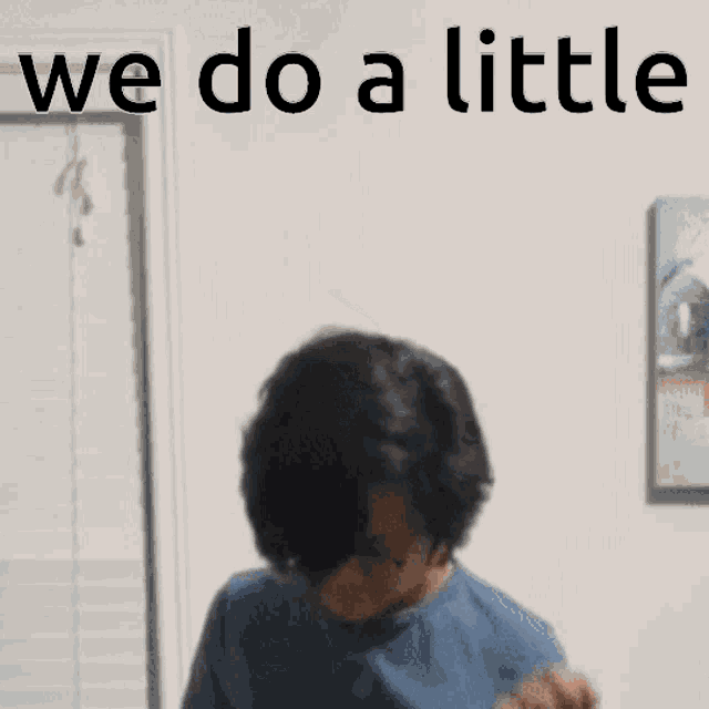 a woman is giving a thumbs up sign in front of a wall that says we do a little .