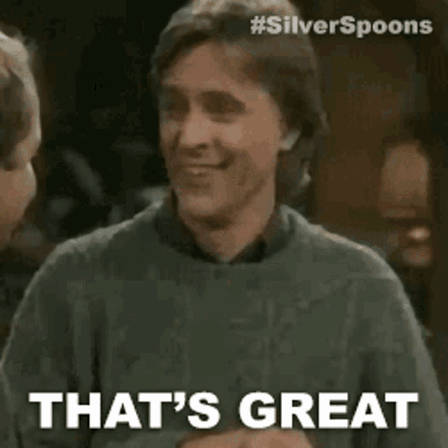 a man in a grey sweater is talking to another man and says `` that 's great '' .
