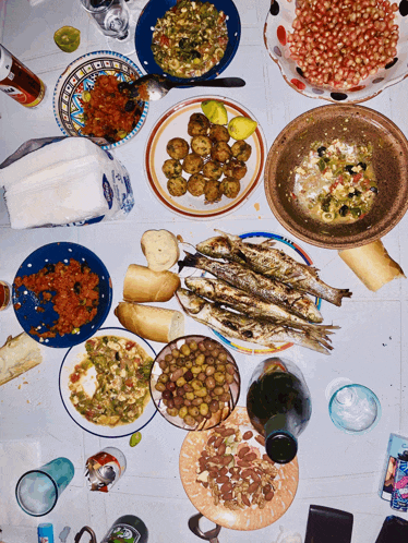 a table topped with a variety of food including a can of coca cola
