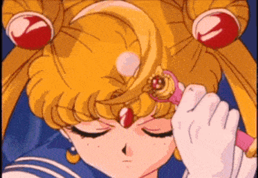 a close up of a sailor moon holding a wand in her hand