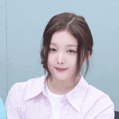 a woman wearing a pink striped shirt and a white shirt