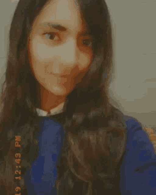 a girl giving a peace sign with a timestamp of 12:49 pm on the bottom