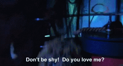 a man with dreadlocks and red lipstick is asking do you love me