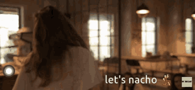 a woman says let 's nacho in a blurry room