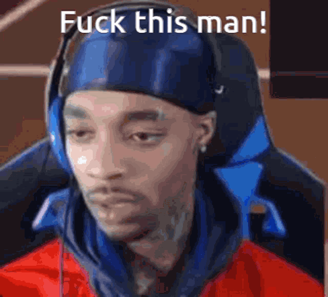 a man wearing headphones and a headband is sitting in a chair and says fuck this man .