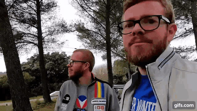 two men standing next to each other with one wearing a shirt that says " a minute "