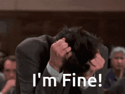 a man in a suit is holding his head and says i 'm fine !