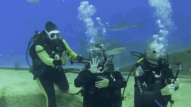 a scuba diver is wearing a shirt that says next