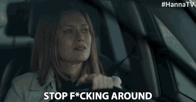 a woman is driving a car and says stop fucking around