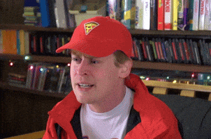 a man wearing a red hat that has a pizza on it