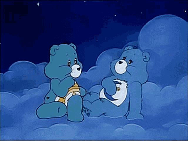 two care bears are sitting next to each other on clouds