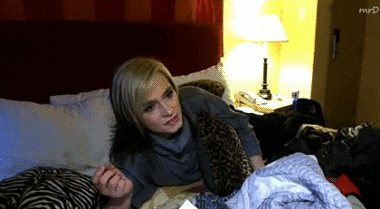 a woman laying on a bed with the word mrd written on the corner