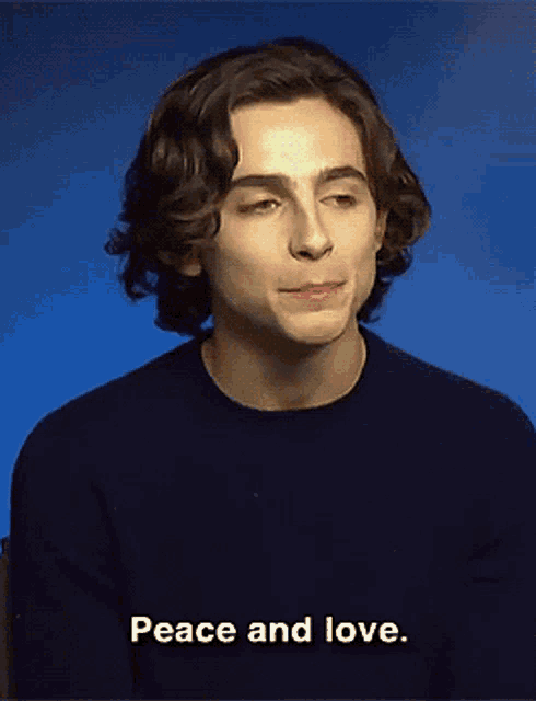 a young man in a black sweater says " peace and love "