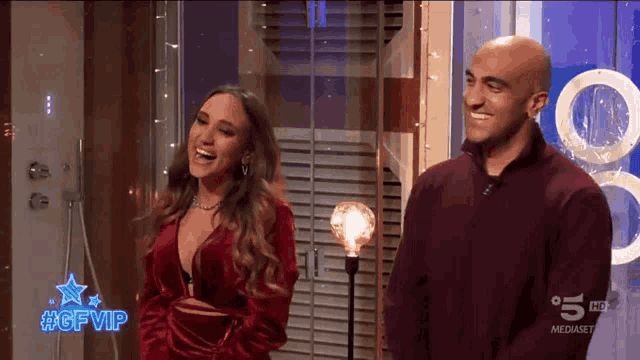 a man and a woman are standing next to each other on a television screen with #gfvip on it