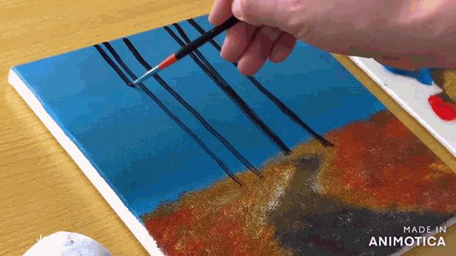 a painting is being painted on a canvas with the words made in animatica on the bottom right