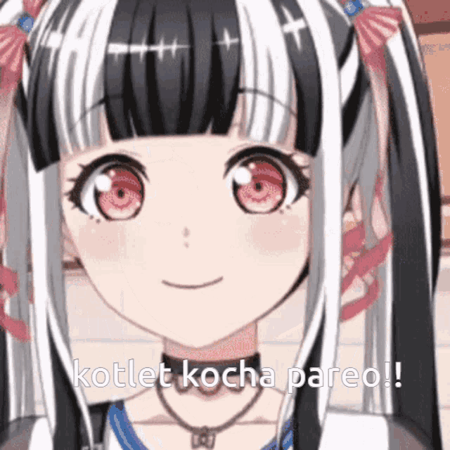 a girl with red eyes and black and white hair is smiling and says kotlet kocha pareo