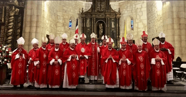 a group of priests are posing for a picture in front of an altar