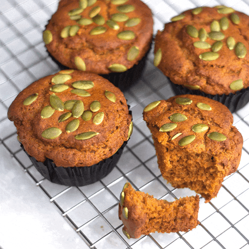 a muffin with a bite taken out of it is on a cooling rack