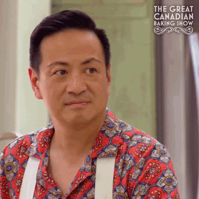 a man is on the great canadian baking show and is wearing a colorful shirt