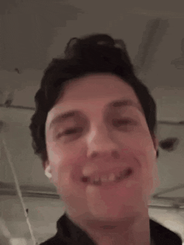 a close up of a man 's face making a funny face and smiling .