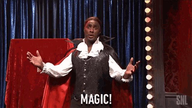 a man in a vampire costume says magic in front of a curtain