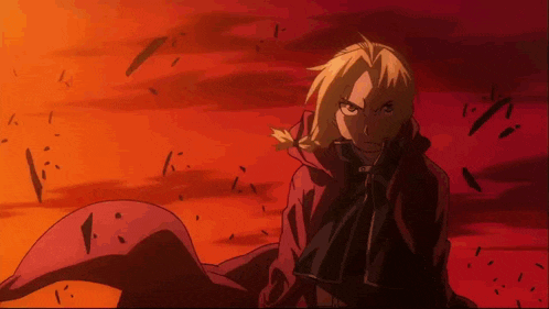 a man in a red cape is standing in front of an orange sky