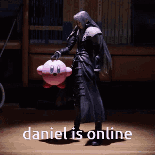 a video game character is holding a pink kirby doll and the caption daniel is online