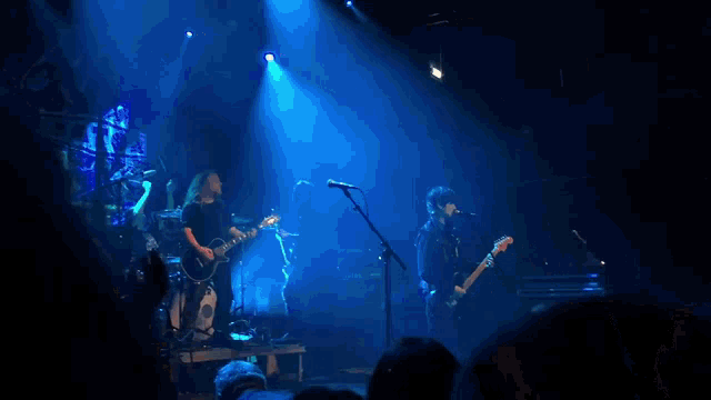 a band on stage with a drum set that says yamaha on it