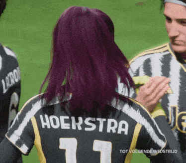 a woman with purple hair wears a hoekstra 11 jersey