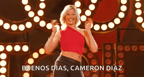a woman in a red top is dancing with the words buenos dias cameron diaz above her