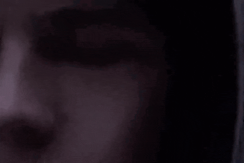 a close up of a person 's face wearing a hooded jacket