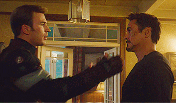captain america and tony stark are shaking hands in a room