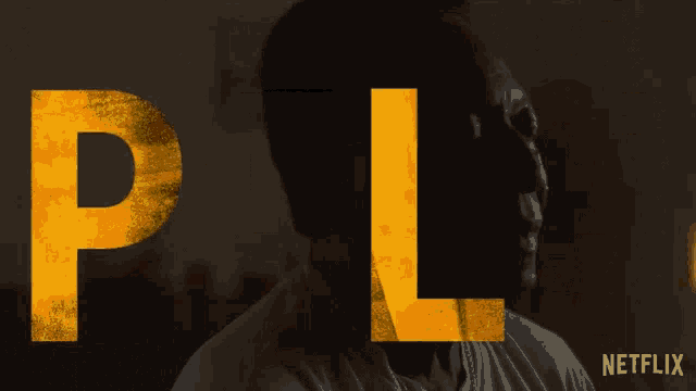 a man 's face is behind the word pel on a netflix ad