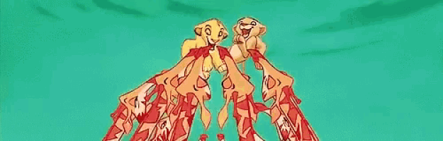 a couple of lion cubs are flying through the air .