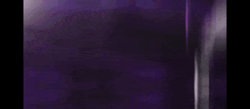 a purple light is coming out of a dark room